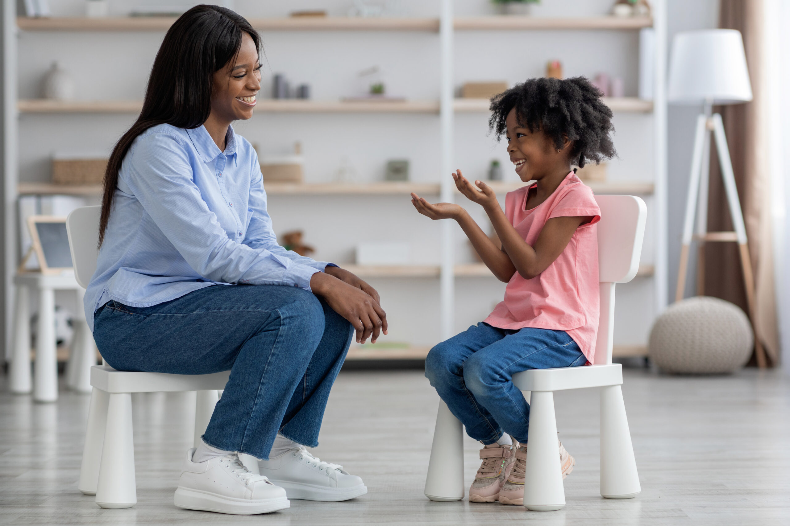 Emotional cute little black girl at child psychologists office